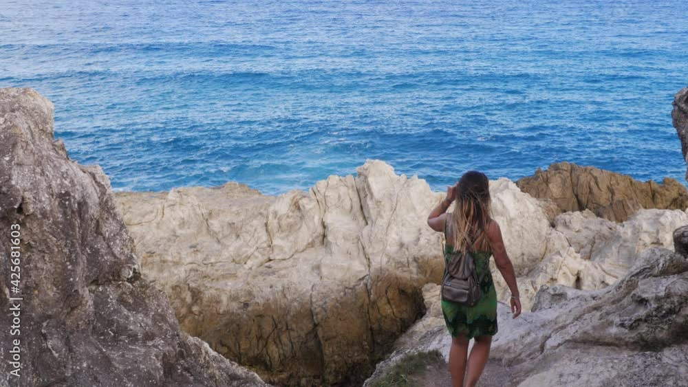 Girl Walking At Boulders Towards Blue Sea - Blue Sea From North Gorge Walk In Point Lookout, Australia. - high angle Girl Walking At Boulders Towards Blue Sea - Blue Sea From North Gorge Walk In Point Lookout, Australia. - high angle