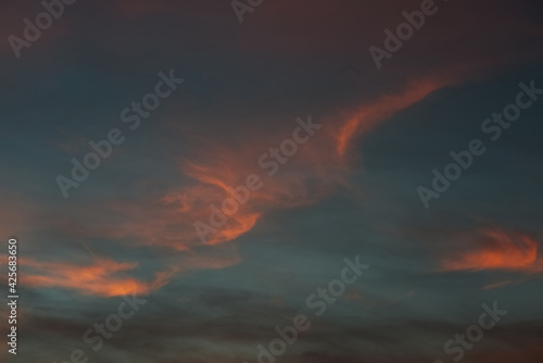 Orange fluffy glow wing like cloud with blue evening sky