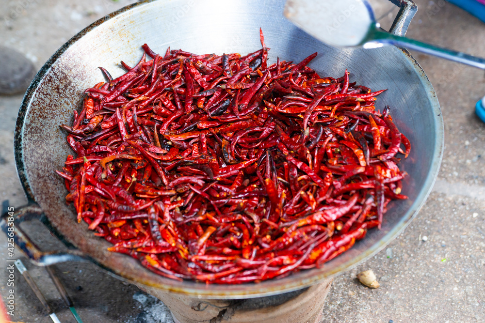 Roasted Dried Chili In the pan To produce cayenne pepper Of Thai people Roasted Dried Chili In the pan To produce cayenne pepper Of Thai people