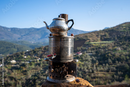 Black teapot in mountains  photo