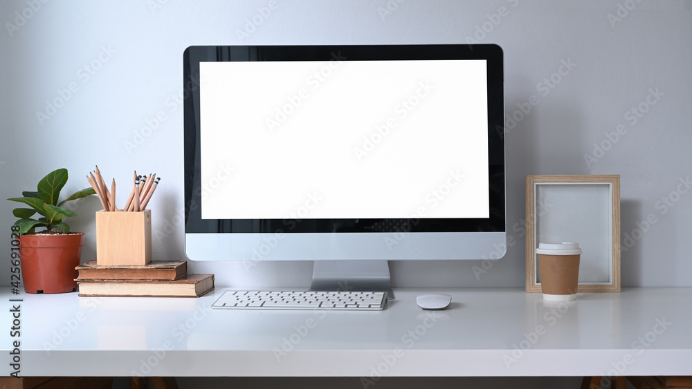 Home office desk with computer, house plant, books and coffee cup. Home office desk with computer, house plant, books and coffee cup.