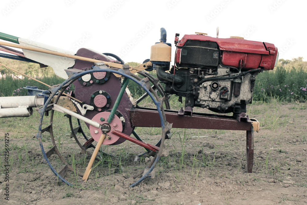 Old technology traditional tractor for farming and harvest in agriculture in Thailand