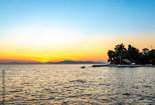 Scenic sunset in Afissos, a traditional village built amphitheatrically on the slopes of Mount Pelion, with view to the Pagasetic Gulf. Magnesia, Thessaly, Greece.