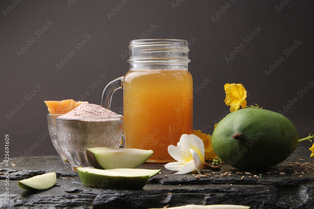 Raw Mango juice - Aam Panna or Panha in a transparent glass with whole green fruit, Raw Mango juice - Aam Panna or Panha in a transparent glass with whole green fruit,