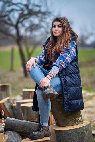 Countryside girl in jeans and plaid shirt