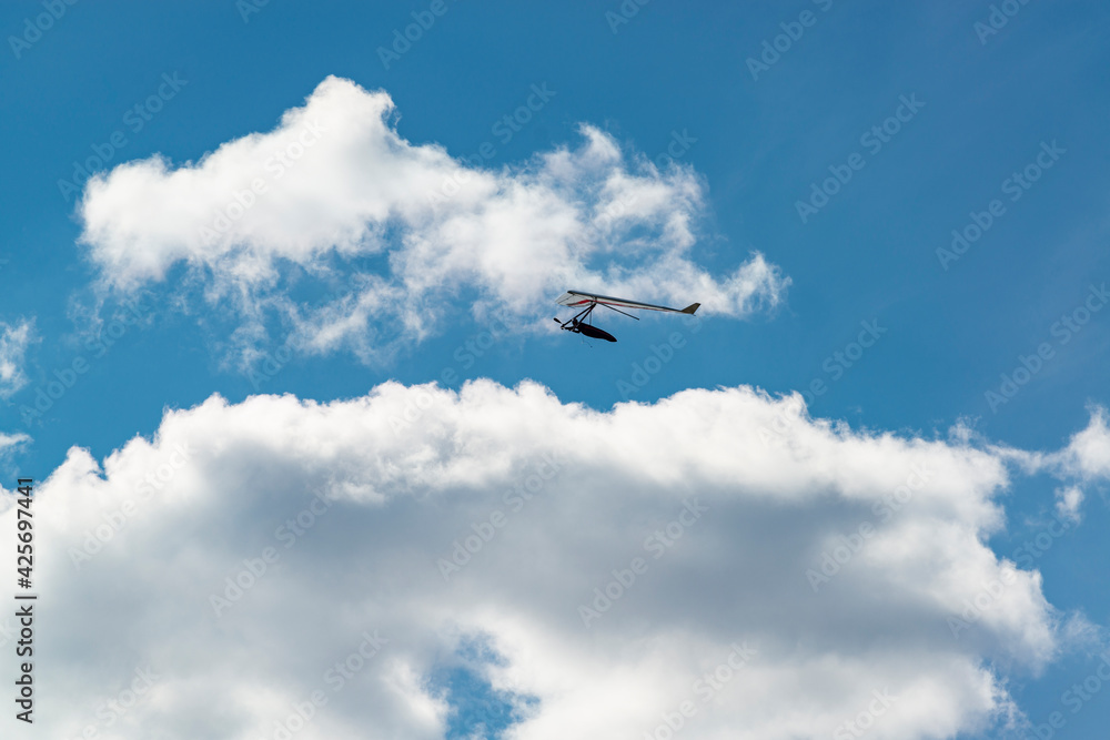 Flying wing in the sky with clouds.