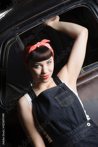 Girl in Jeans in front of an old truck