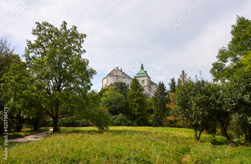 Undefined castle in East Europe. Beautiful stronghold against blue sky in forest