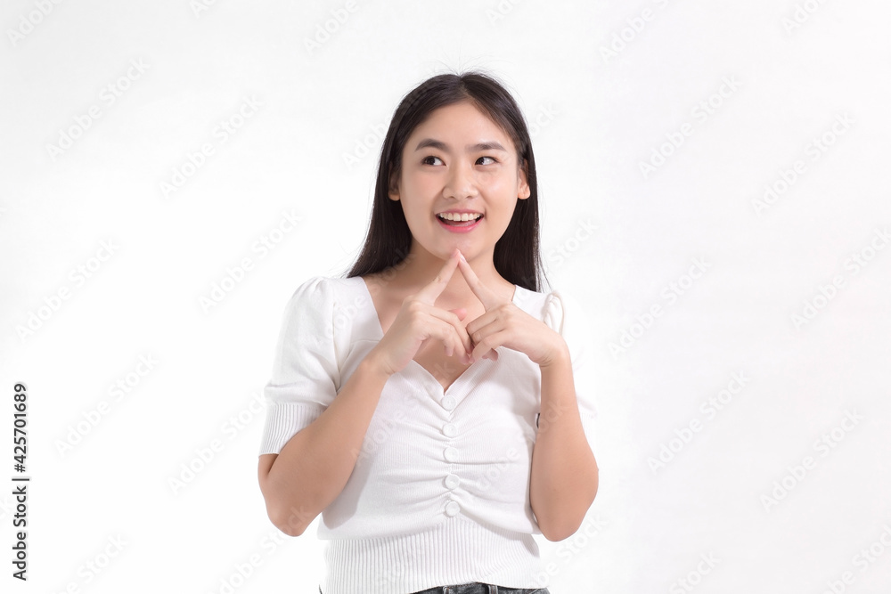 Asian beauty lady standing smiling in pink dress is looking at something while touching her face on a white background. Asian beauty lady standing smiling in pink dress is looking at something while touching her face on a white background.