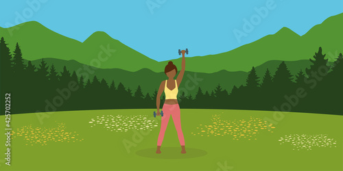 sporty girl does outdoor sport with dumbbells on a summer meadow © krissikunterbunt