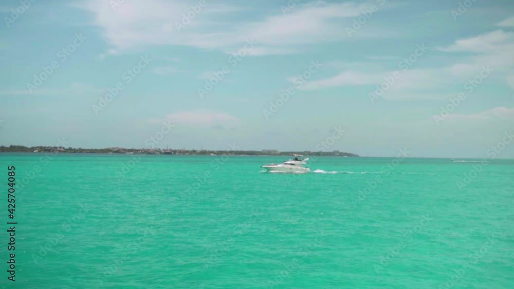 zooming onto a yacht swimming in the gulf of mexico, carribean water