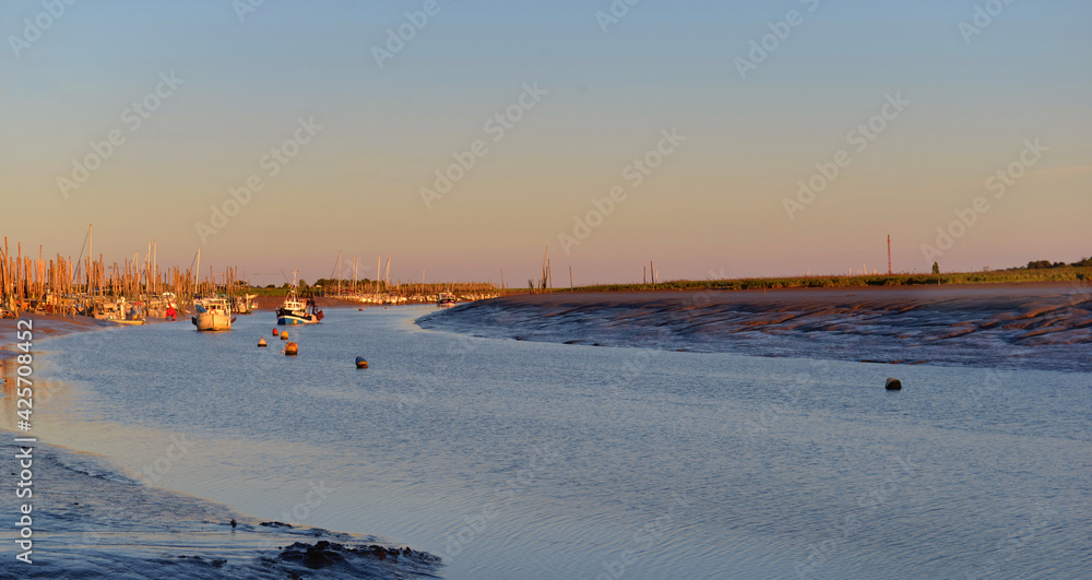 beautiful sunset on the fairway  with little fishing boats background at low tide