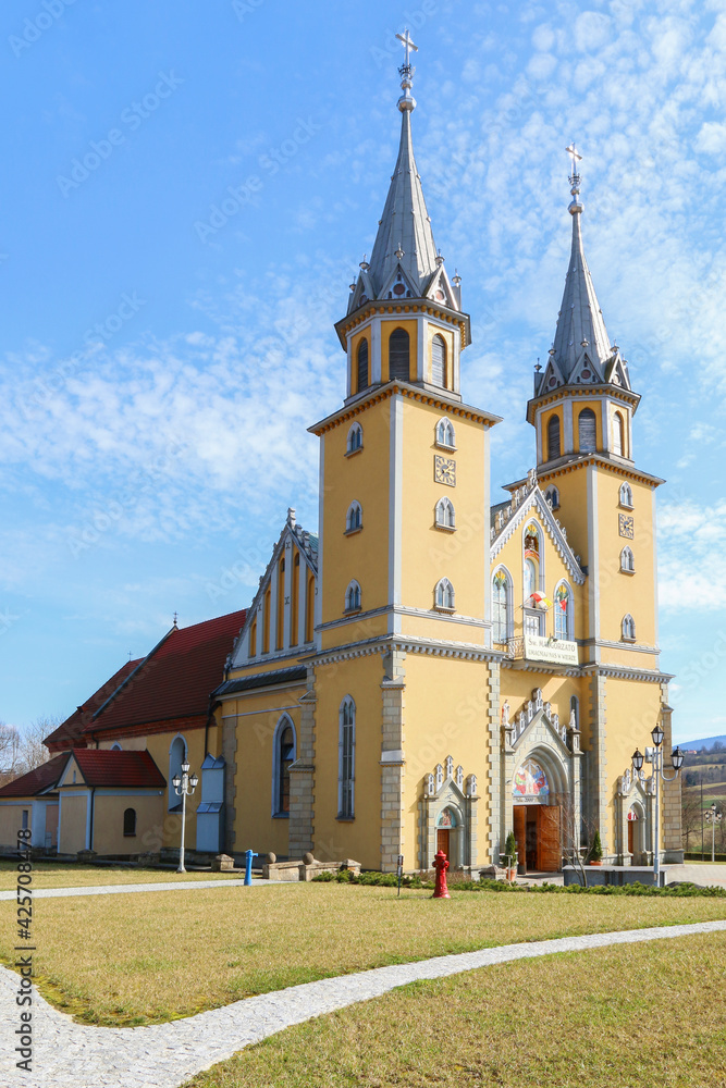 TRZCIANA, POLAND - MARCH 31, 2021:  Church and garden