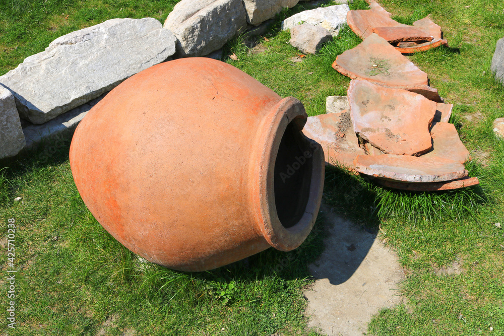 old amphora and other archaeological ruins on the grass with different materials, such as stone or clay, representing ancient historical civilizations old amphora and other archaeological ruins on the grass with different materials, such as stone or clay, representing ancient historical civilizations