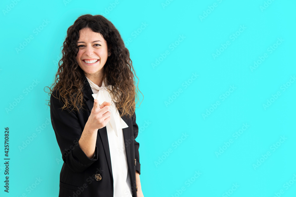 Portrait of a pretty happy girl pointing at the camera - Smiling woman on colorful background in business clothes. Portrait of a pretty happy girl pointing at the camera - Smiling woman on colorful background in business clothes.
