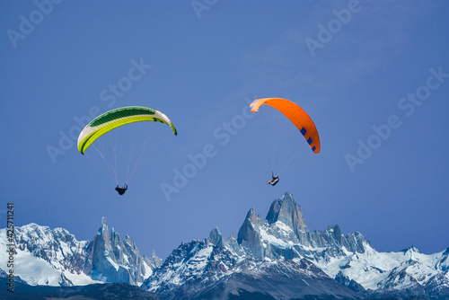 Paragliders flying above the mountains in sunshine
