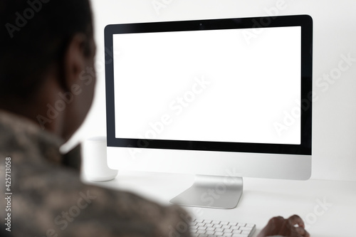 Military officer using computer desktop photo