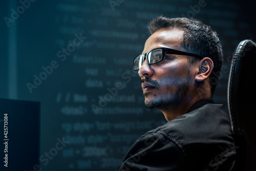 Man analysing binary code on virtual screen photo