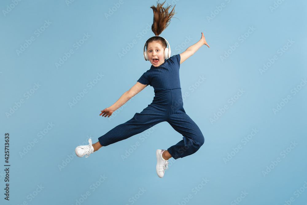 Pretty caucasian girl portrait isolated on blue studio background with copyspace