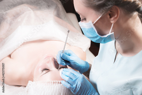 Close-up Professional face cleaning. Mechanical facial cleansing procedure. Peeling of the skin of the face.