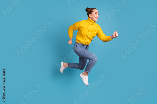 Full size profile portrait of crazy energetic lady running look empty space isolated on blue color background