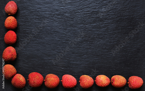 Photography of litchis on slate background for menus, labels or signs