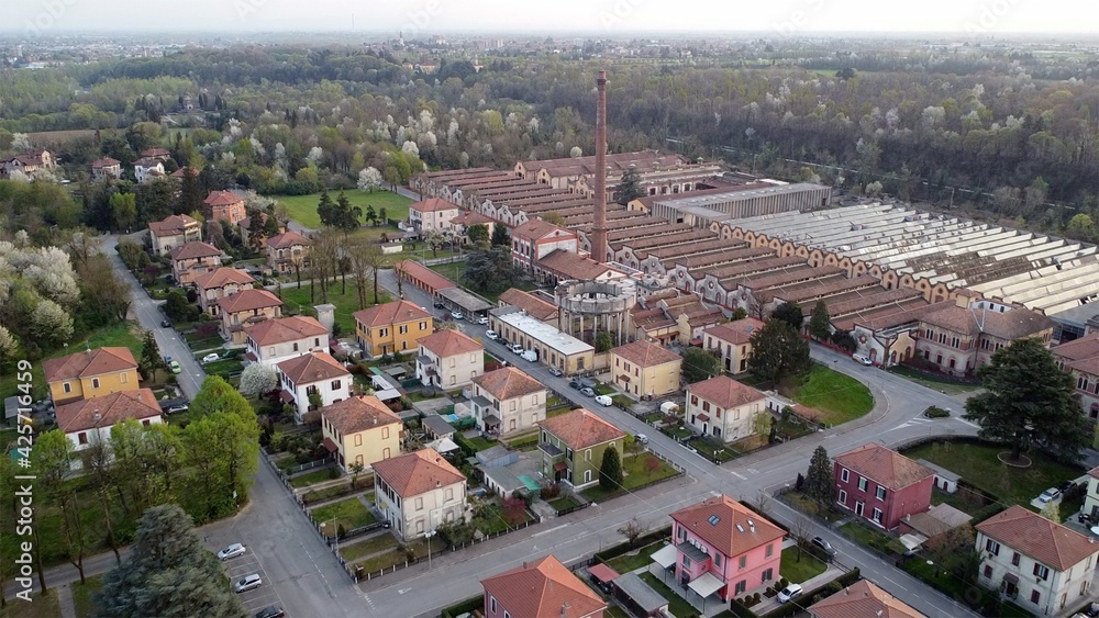 Europe, Italy, Crespi d'Adda closed to Bergamo and Milan is the best preserved workers' village , Founded in 1877 by Cristoforo Crespi - drone aerial view of textile industry - Unesco Heritage world