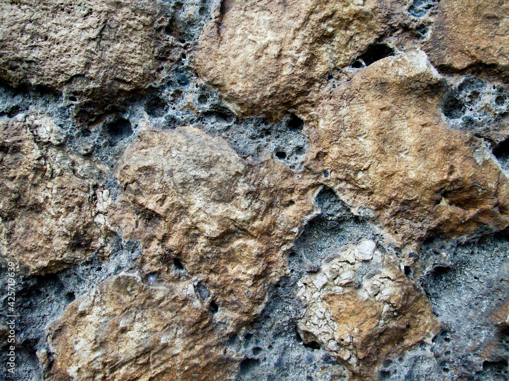 Rough and rough texture of the stone with depressions on the surface Rough and rough texture of the stone with depressions on the surface