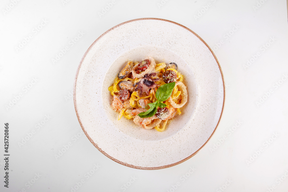 fresh pasta with seafood on a white plate in the studio fresh pasta with seafood on a white plate in the studio