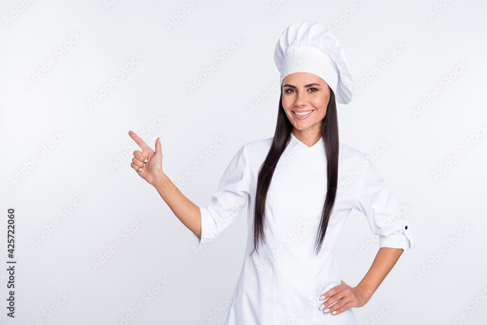 Photo of pretty confident girl put hand on waist indicate finger empty space offer isolated on white color background Photo of pretty confident girl put hand on waist indicate finger empty space offer isolated on white color background