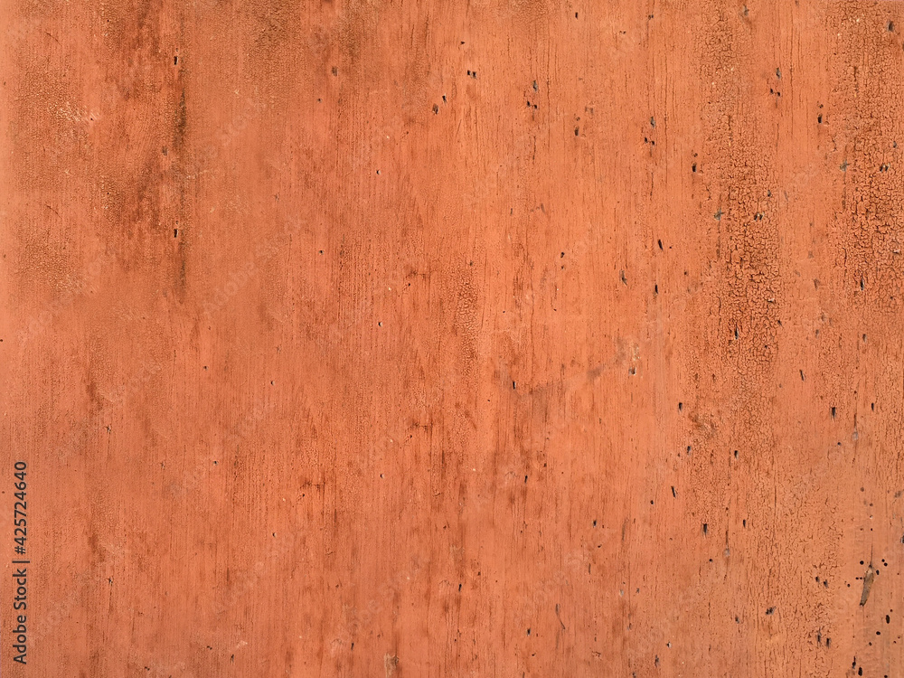 Old exfoliating brown paint from the wood surface of the board close-up.Texture or background