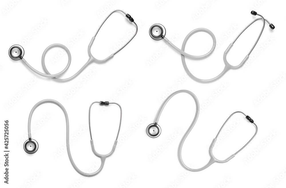 Set with stethoscopes on white background, top view Set with stethoscopes on white background, top view