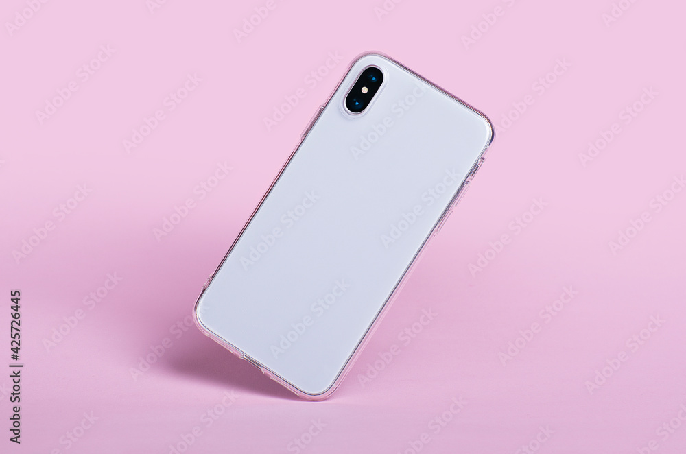Smartphone in clear silicone case falls down, back view. iPhone X case mockup isolated on pink background Smartphone in clear silicone case falls down, back view. iPhone X case mockup isolated on pink background