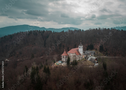 Aerial drone view of Saint Mohor and Fortunat church on the top of the hill in central Slovenia close to Lukovica.