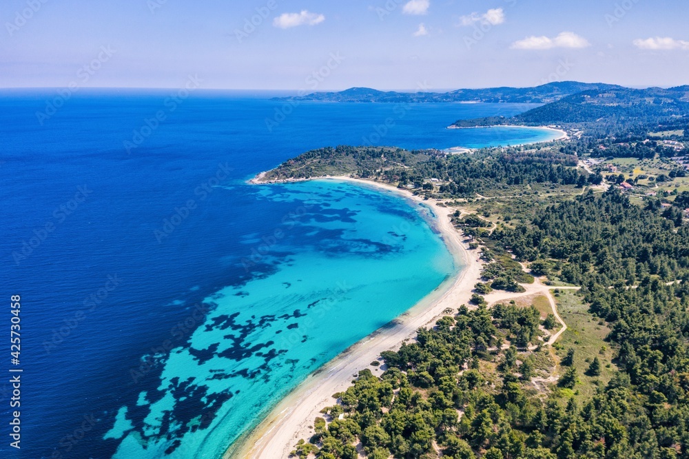 Beautiful Beach With Golden Sand And Clear Water. Turquoise coast with blue water and golden sand in Europe aerial drone photo