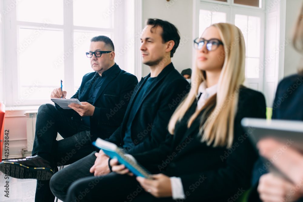 Really good info. Group of young business people sitting on conference together Really good info. Group of young business people sitting on conference together