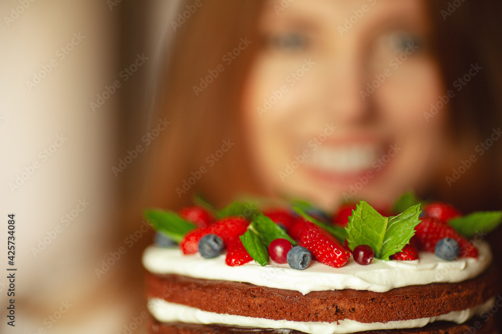 Delicious present for lovely beautiful woman on her Birthday. White shiny smile. Close up defocused portrait with chocolate cake. Copy-space. Indoor shot Delicious present for lovely beautiful woman on her Birthday. White shiny smile. Close up defocused portrait with chocolate cake. Copy-space. Indoor shot