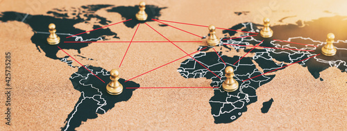 concept of geopolitics or worldwide economy. chess figures placed on map banner photo