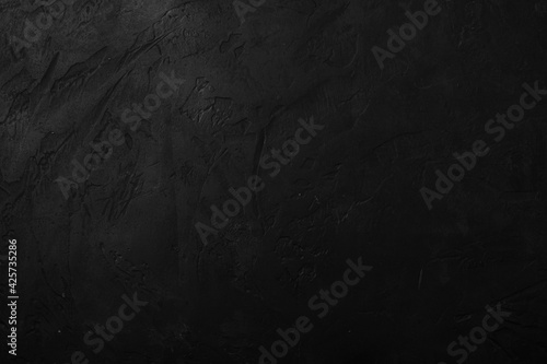 Black stone textured background, dark concrete surface