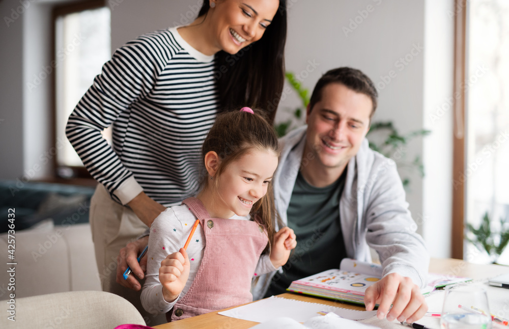 Fototapeta premium Parents with school girl indoors at home, distance learning and home office.