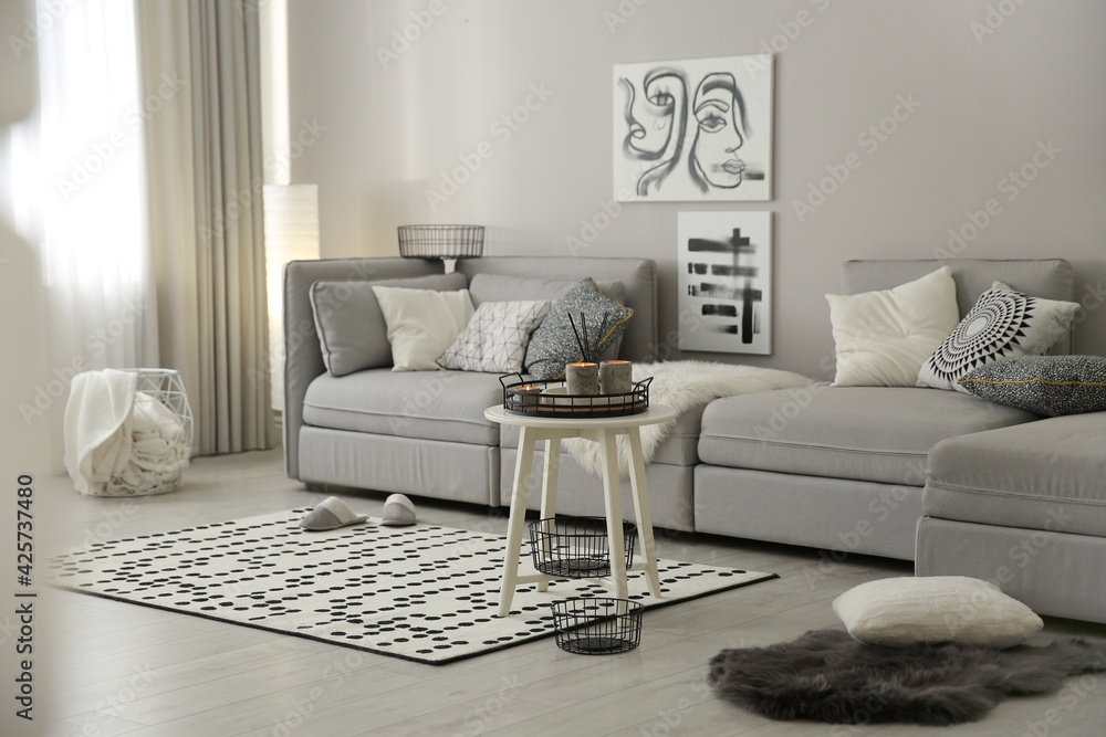 Fototapeta premium Cozy living room interior with big grey sofa