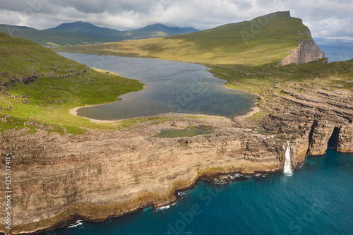 Faroe islands dramatic coastline in Vagar. Leitisvatn lake photo