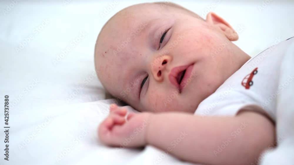 sleeping 3 months baby opening eyes while dreaming close-up view infant asleep moving sleeping 3 months baby opening eyes while dreaming close-up view infant asleep moving