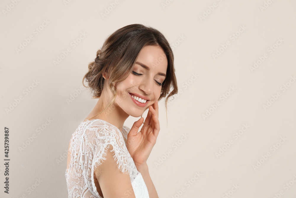 Young woman with beautiful hairstyle on beige background. Space for text Young woman with beautiful hairstyle on beige background. Space for text