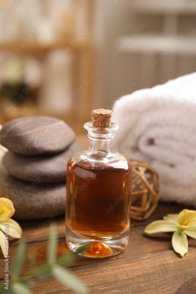 Beautiful spa composition with essential oil on wooden table indoors Beautiful spa composition with essential oil on wooden table indoors