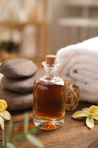 Beautiful spa composition with essential oil on wooden table indoors