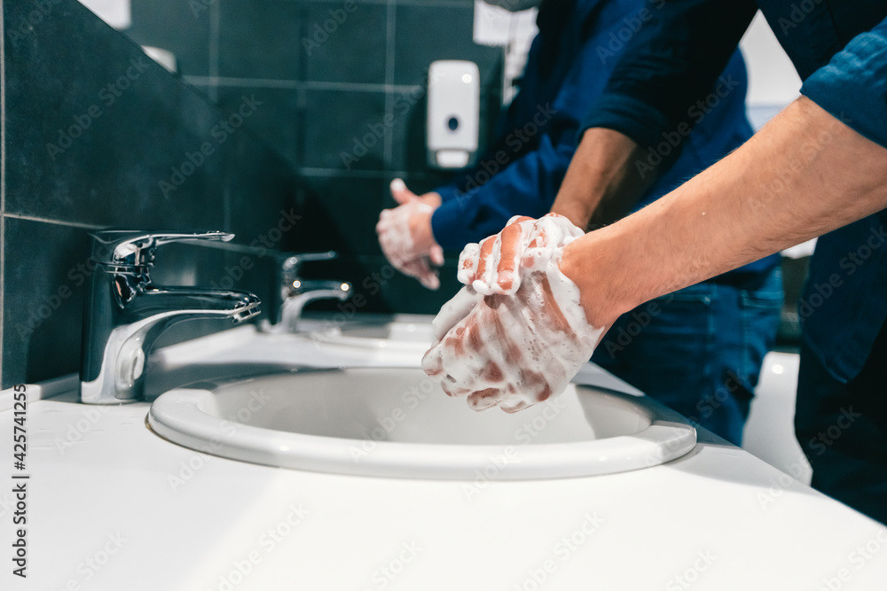 close up. employees wash their hands thoroughly