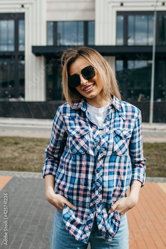 Fashion portrait of beautiful woman with beautiful face, wearing grunge plaid shirt. Posing alone. © andrew_shots