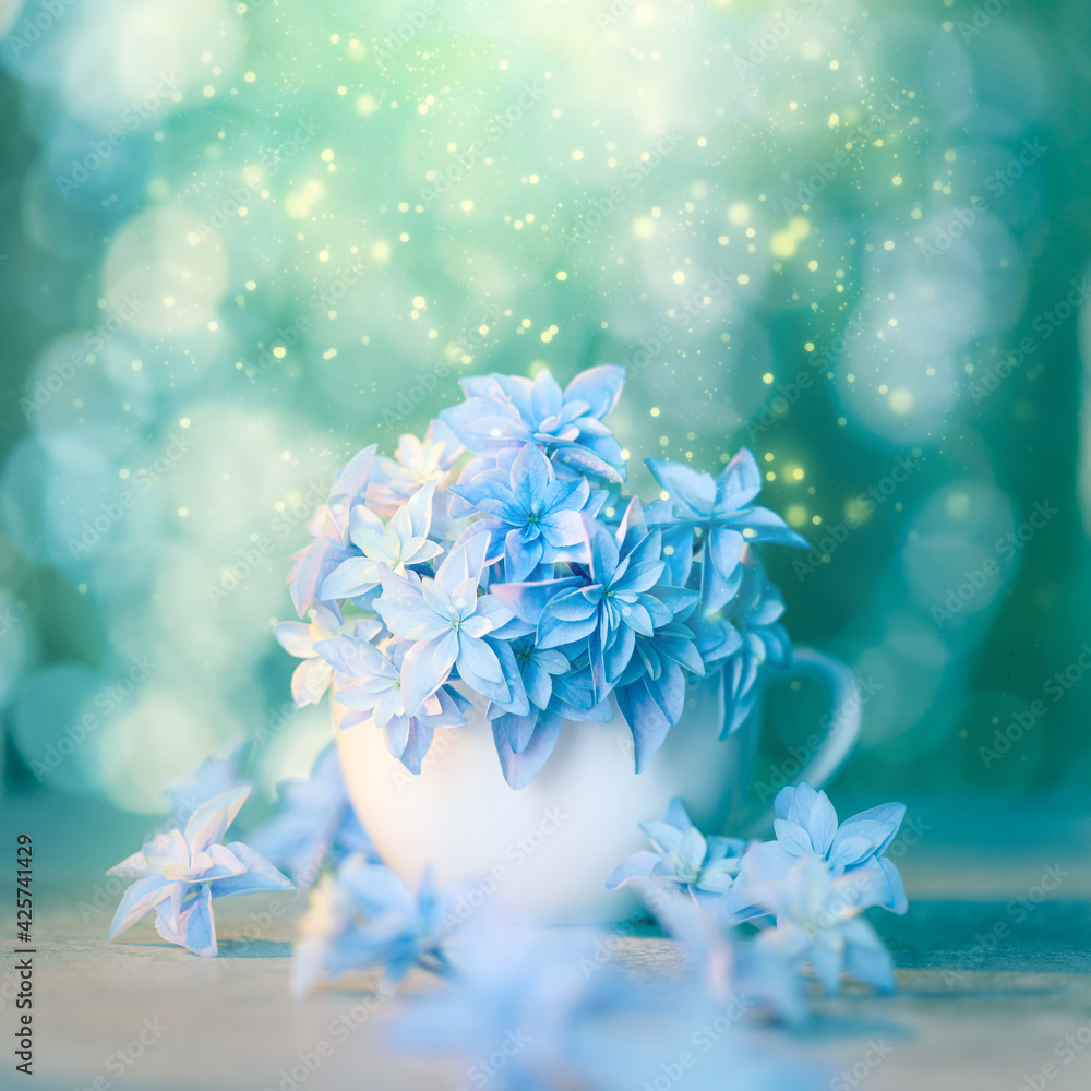 Romantic floral artistic background with blue flowers and bokeh