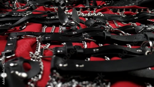 A set of erotic toys for BDSM. Sex slavery game with whip, gag and leather face mask. Intimate sex games leather belts